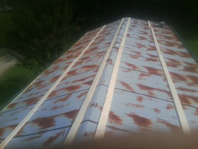 Rusted metal roof panels with new wood purlins before replacement — Storm Damage Roof Repair in Joanna by Roofing Brothers
