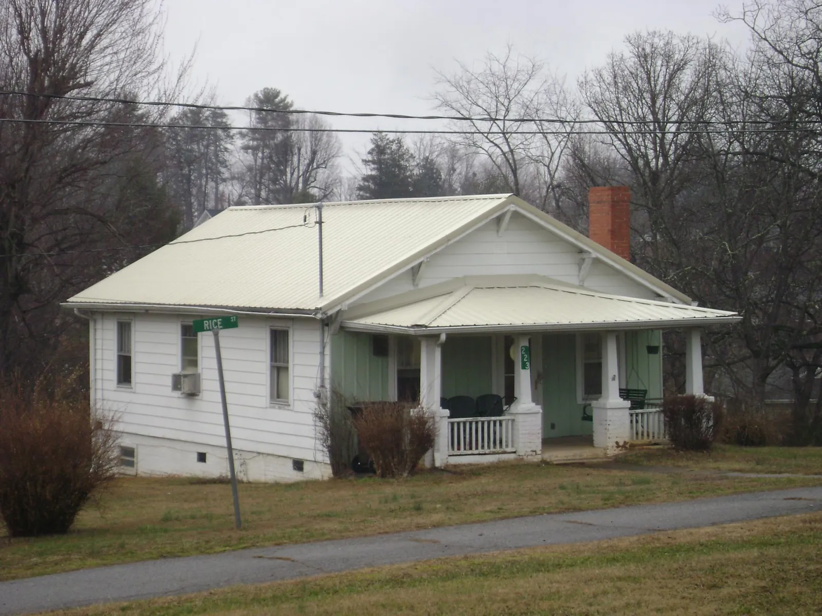 White metal roof on a craftsman bungalow at a street corner in Joanna
